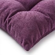 small dog resting on large tufted pet mat