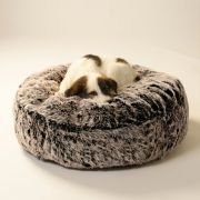 dog curled up in round fur dog bed with thick plush fur