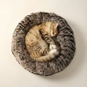cat nestled in cozy round fur dog bed