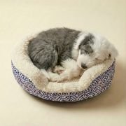 small dog curled up in sherpa bolster dog bed with artisan print