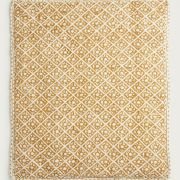 cotton pet blanket draped over bolster dog bed